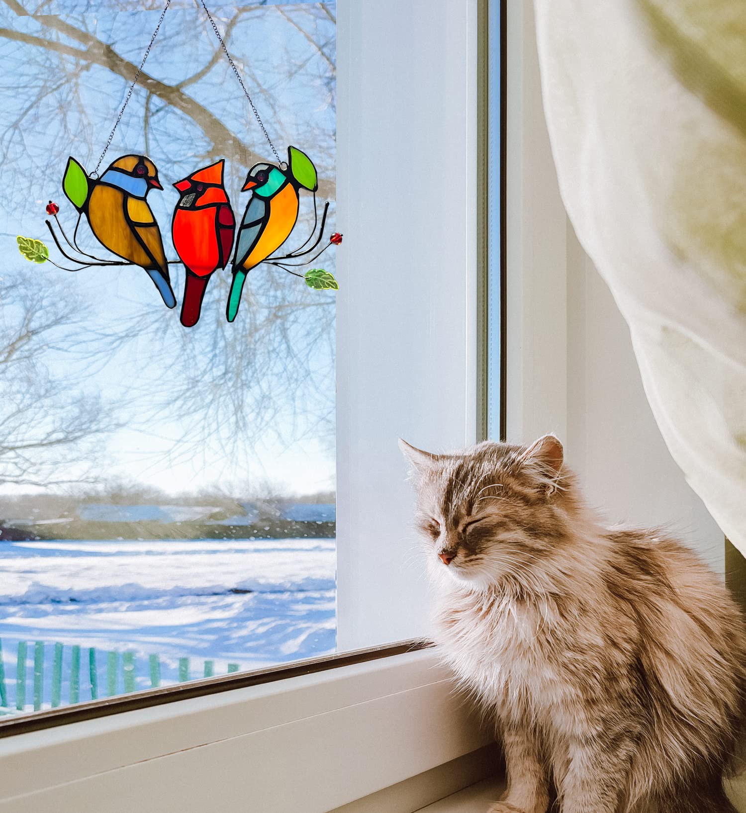WOJIANA suncatcher hanging in a sunny window casting colorful reflections and warm ambiance