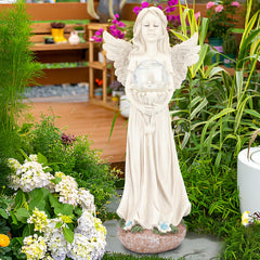 WONDER GARDEN angel placed in a flower bed giving peaceful garden ambiance