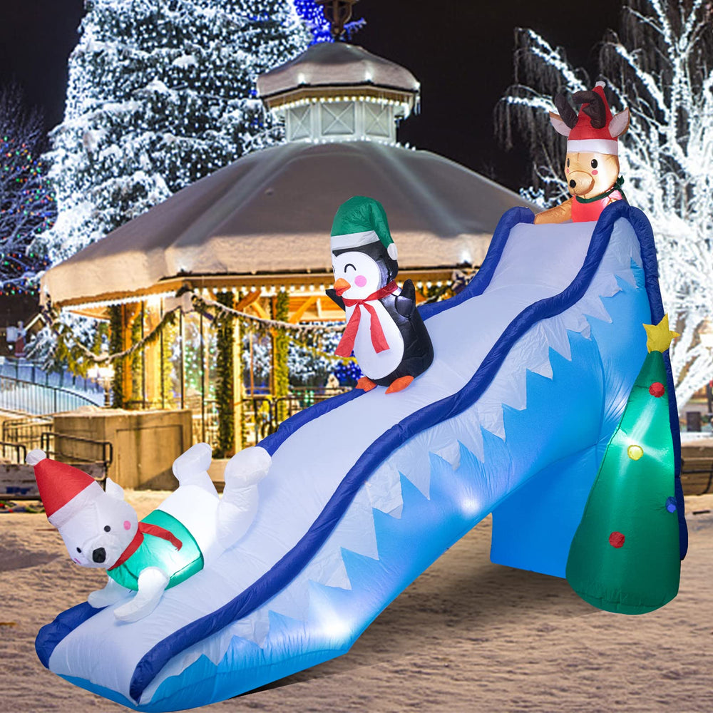 WONDER GARDEN front view of inflatable penguin slide highlighting festive scene