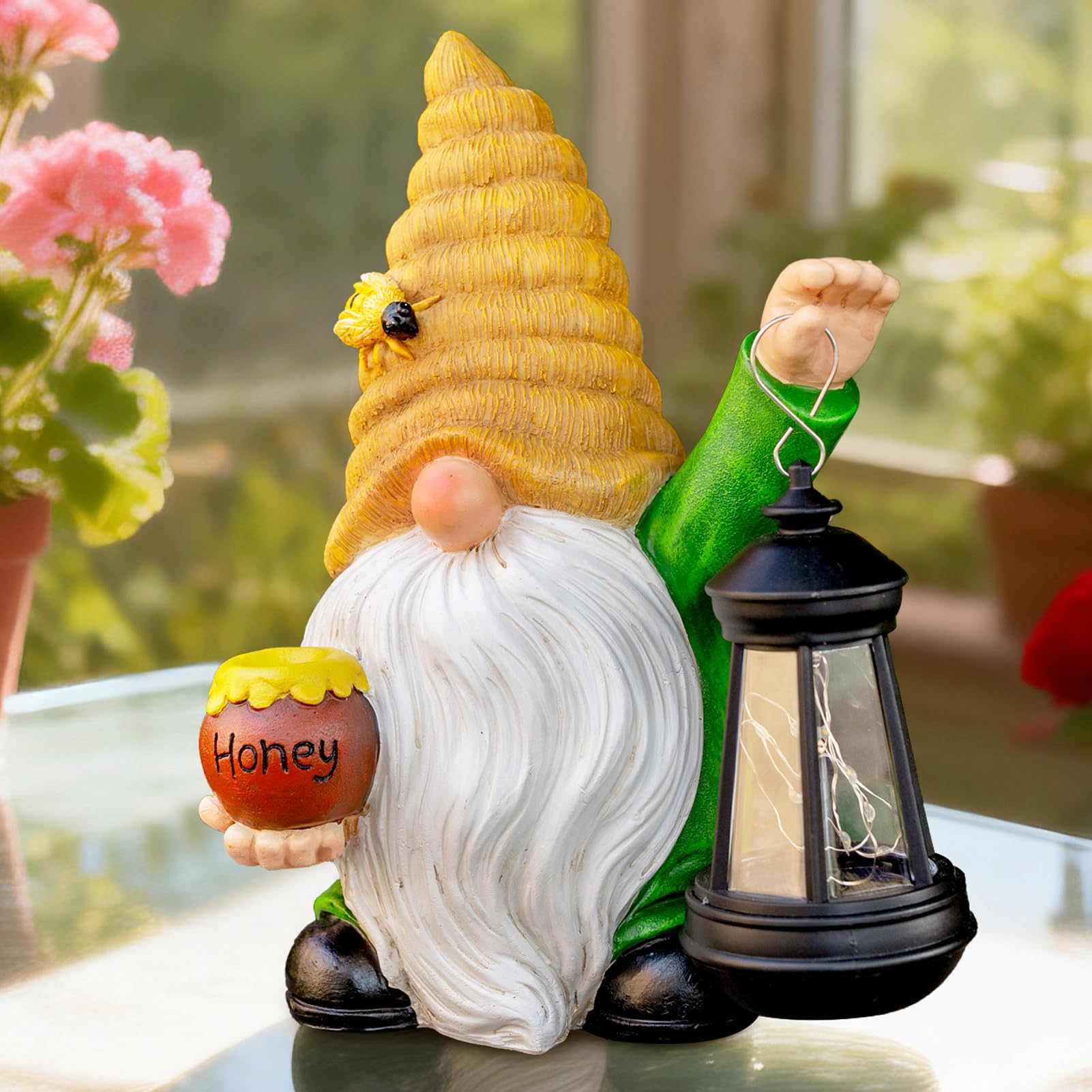 WONDHOME bee gnome beside a hand for size comparison and easy placement