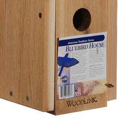 Woodlink mounted on a pole in a yard providing an open perch for birds