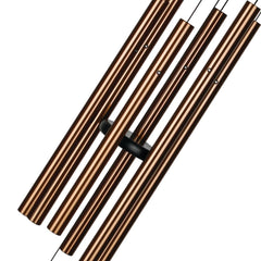 Woodstock Chimes hanging in garden setting, creates tranquil outdoor ambiance