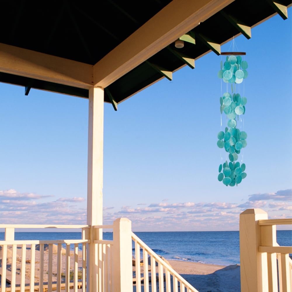 Woodstock Chimes chime held by hand for scale showing 40-inch length and size relationship