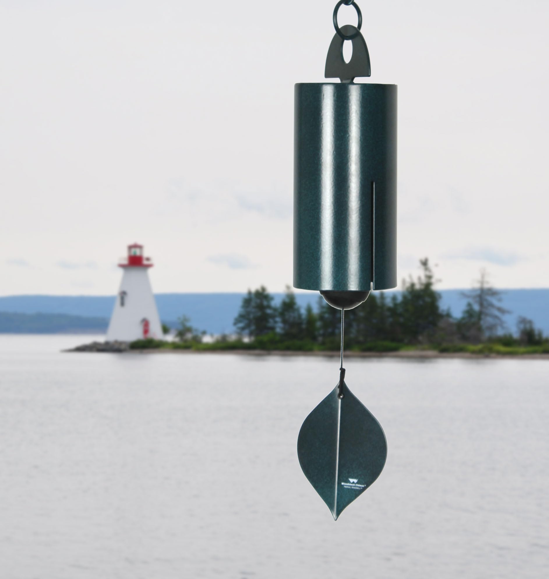 Woodstock Chimes Heroic close-up of textured steel bell and side slots benefit: reveals acoustic craftsmanship
