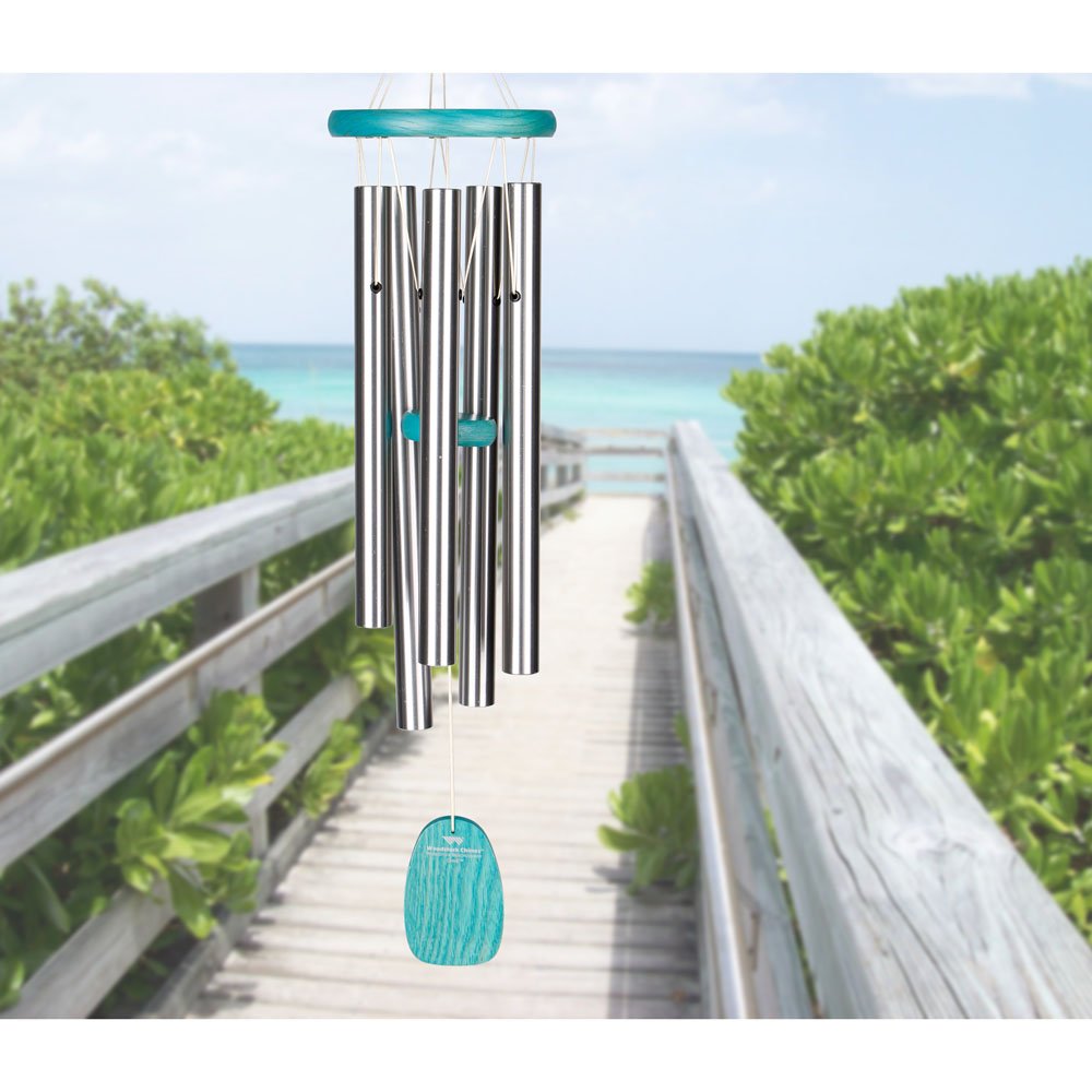Woodstock Chimes displayed on a porch railing showing scale and tranquil outdoor decor benefit