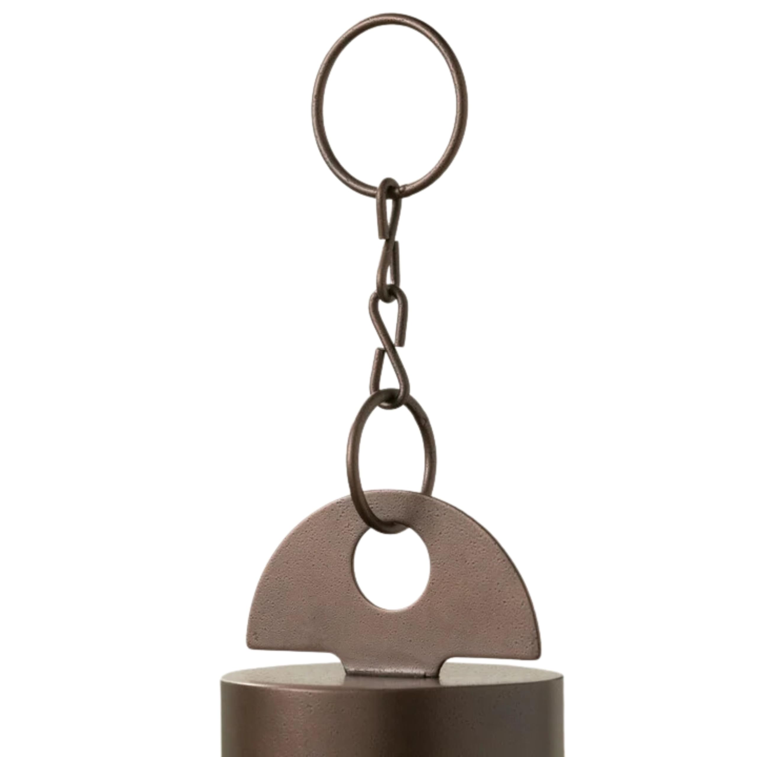 Woodstock Chimes hero windbell hanging on a porch creating a serene garden soundscape for relaxation