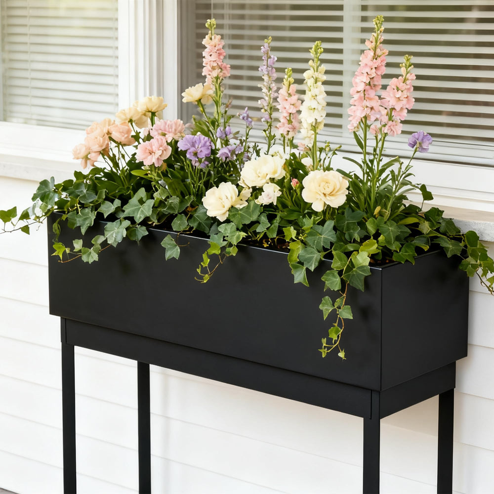 WORTH planter on a patio with flowers, displays decorative appeal and outdoor versatility benefit