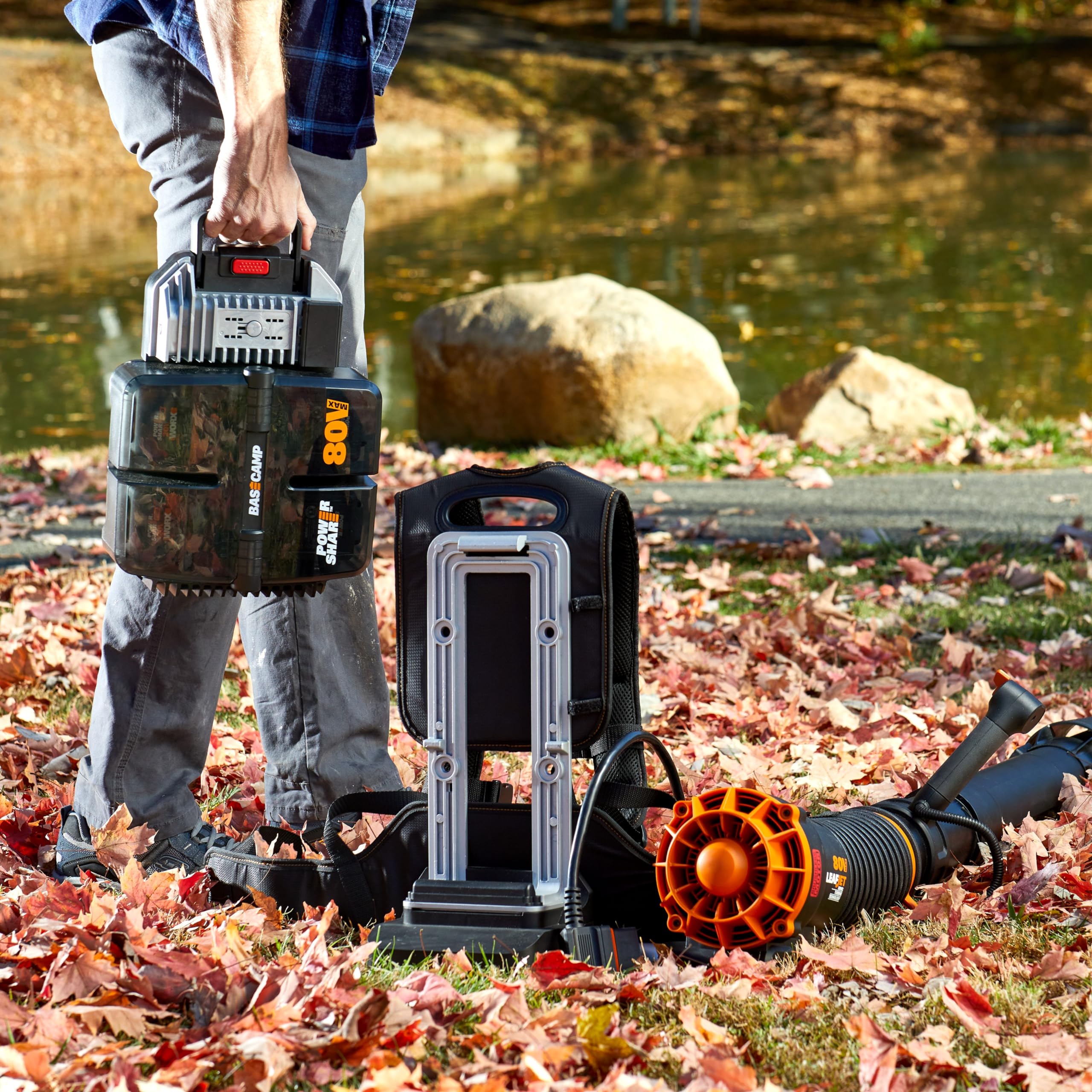 WORX WG572 in-use blowing wet leaves from a driveway to speed yard cleanup
