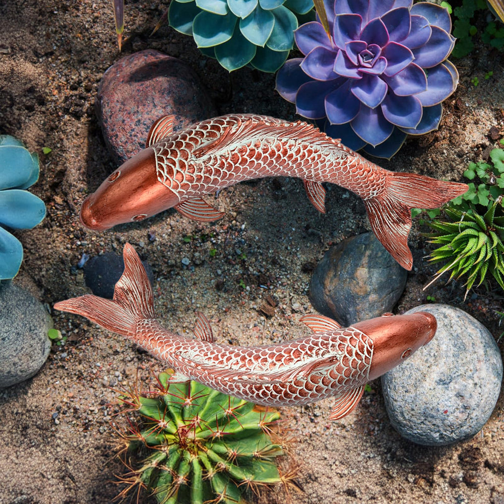 Wosuine koi sculptures staged in patio planter adding instant garden style