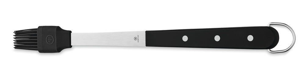 Wüsthof tongs in use over grill delivering precise secure grip