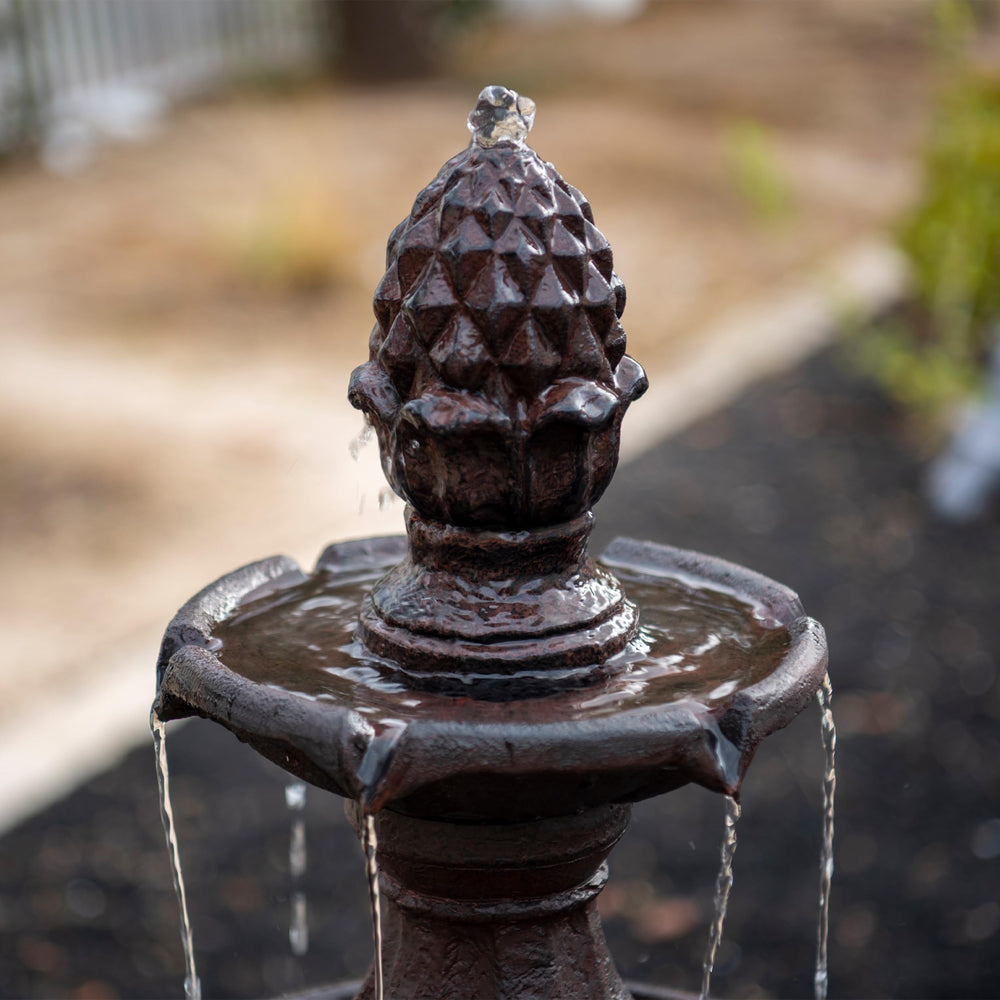 XBrand fountain in garden with plants creating a tranquil setting