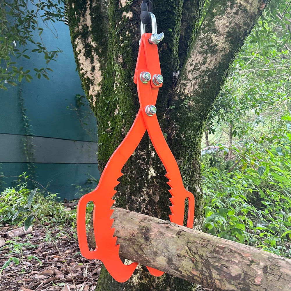 XROPURR tongs attached to a tractor towing a log demonstrating efficient skidding and control
