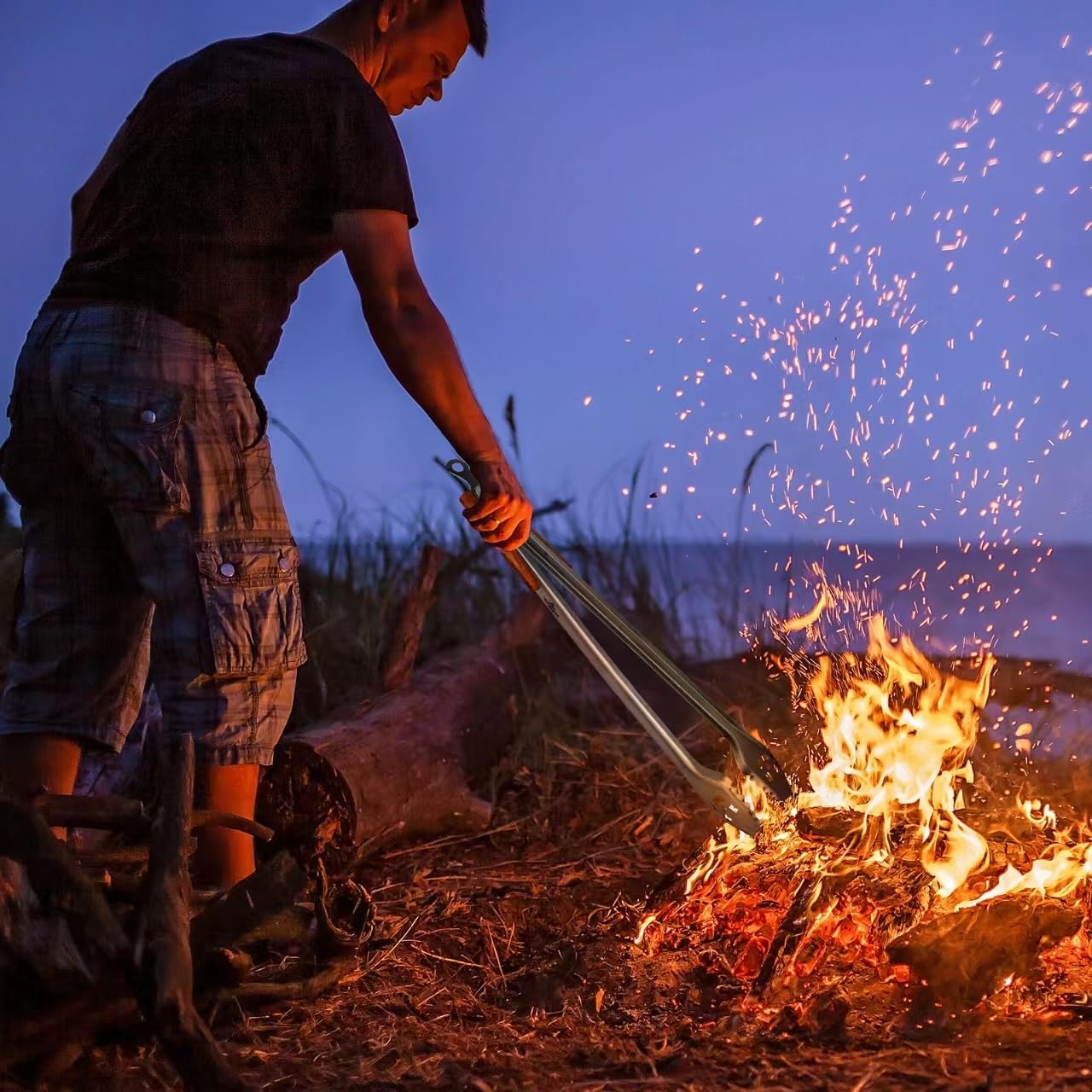 XUDAKAIXIN tongs in use at campfire enabling safe log adjustment