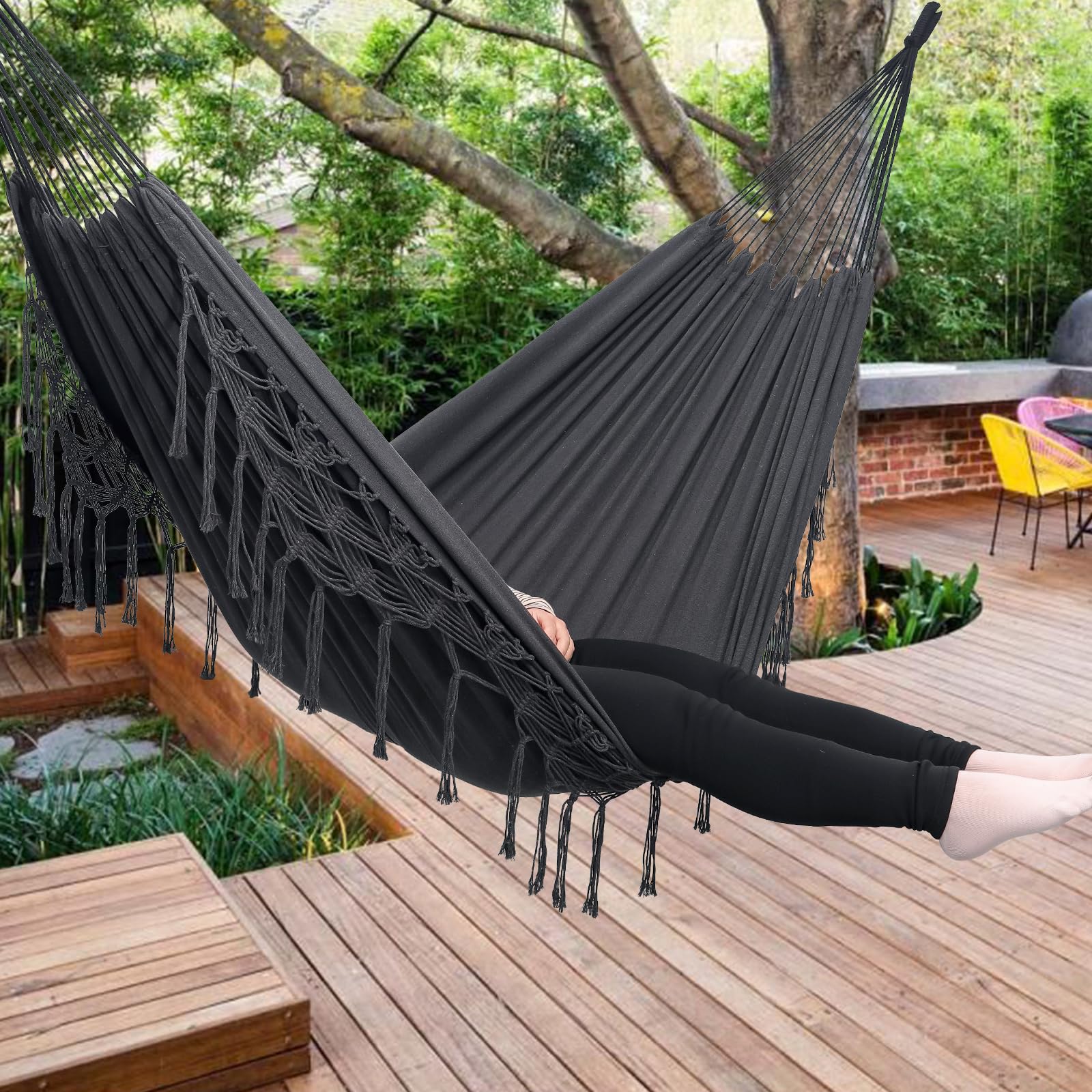 YAERSI hammock hung on patio with users relaxing demonstrating outdoor lifestyle use