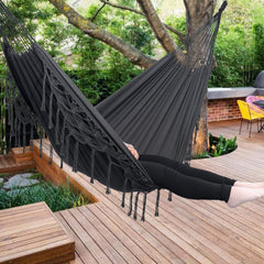 YAERSI hammock hung on patio with users relaxing demonstrating outdoor lifestyle use