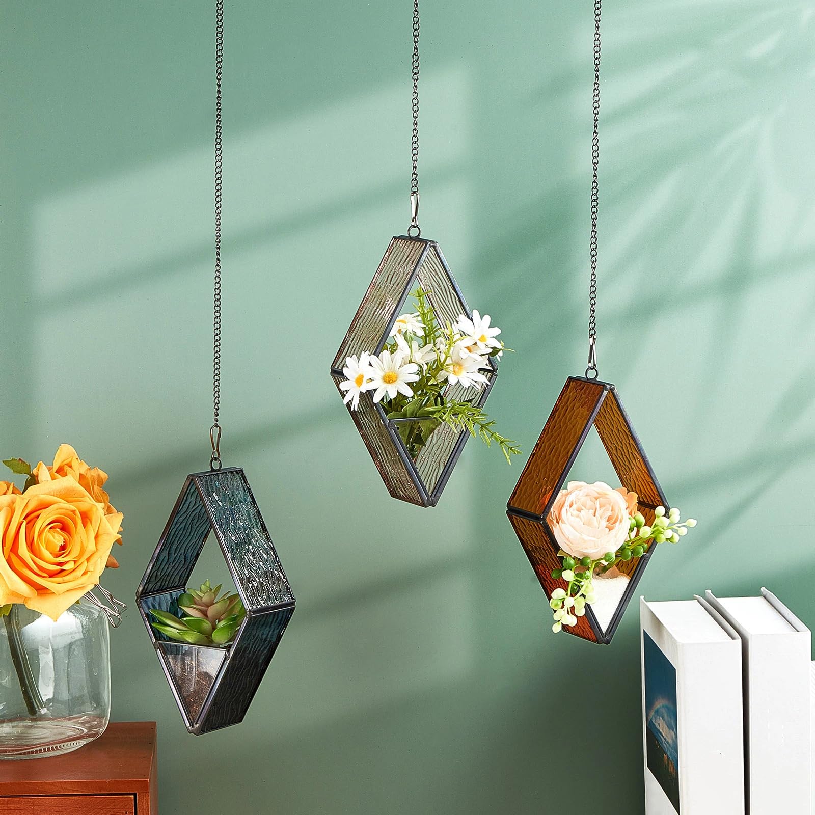 Yaomiao terrariums hung in a sunlit window creating colorful room accents
