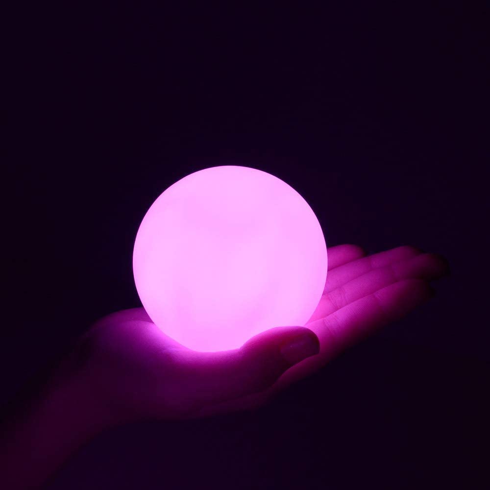 YESIE orb floating on pool water at night providing colorful, even illumination