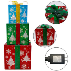 YOFIT lit present beside Christmas tree adding warm ambient lighting