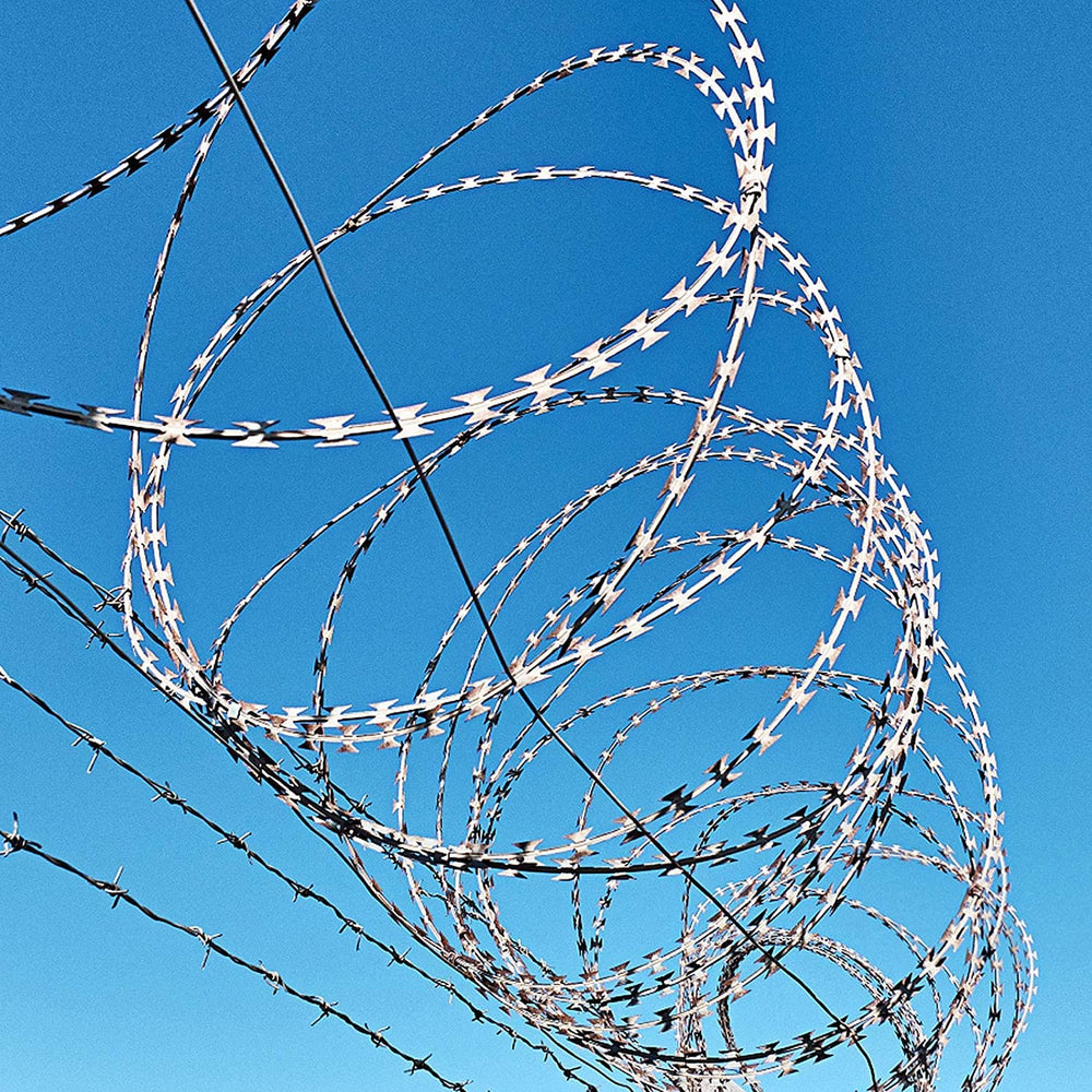 YXJSTO perimeter view of property with razor wire showing effective deterrent