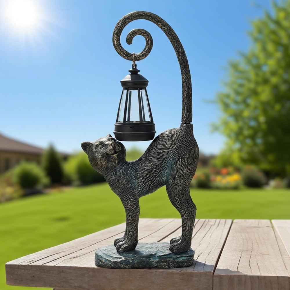ZioWio cat statue placed among flowers to show landscaping accent and charm