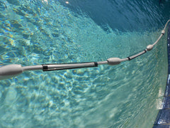 Zodiac Cleaner Clip shown on hose in pool setting, keeps cleaner moving smoothly