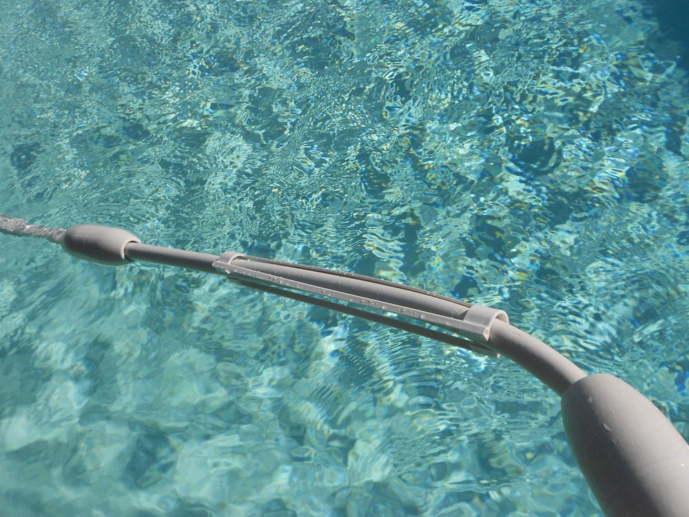 Zodiac Cleaner Clip attached to a 1-inch pressure hose, prevents twisting and knots