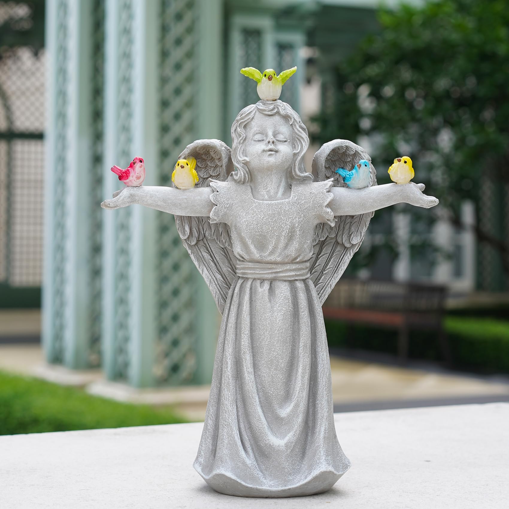 zuzuzen angel statue glowing at night, provides soft pathway illumination