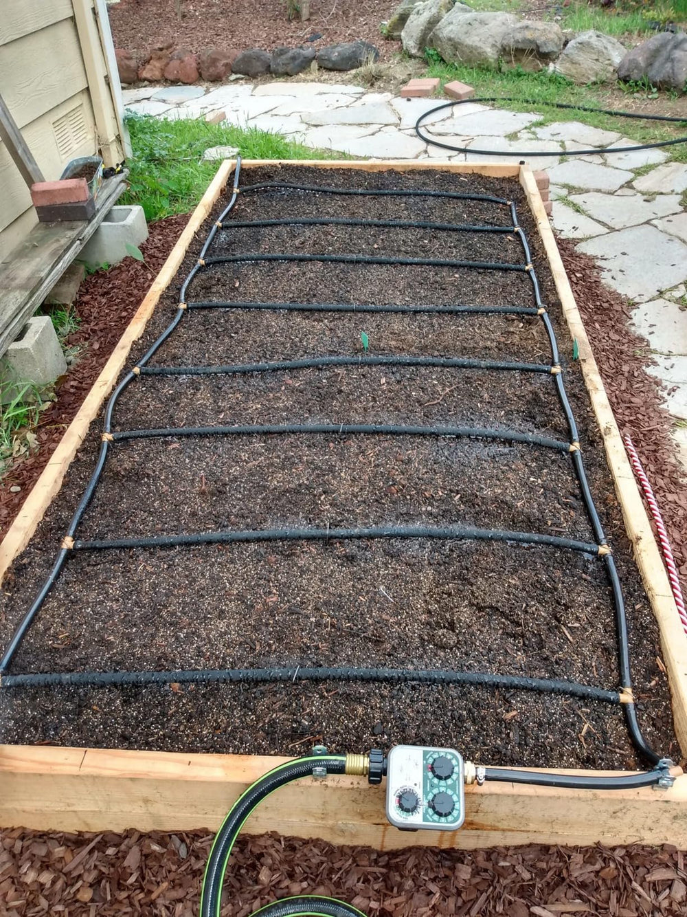 ZY-hosetube in garden beside plants showing lifestyle setup benefit tidy functional irrigation